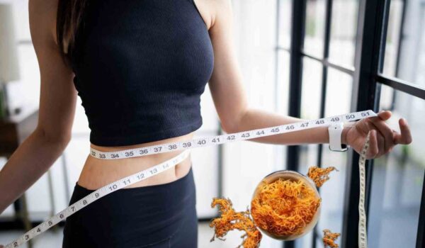 woman measuring waist with sea moss